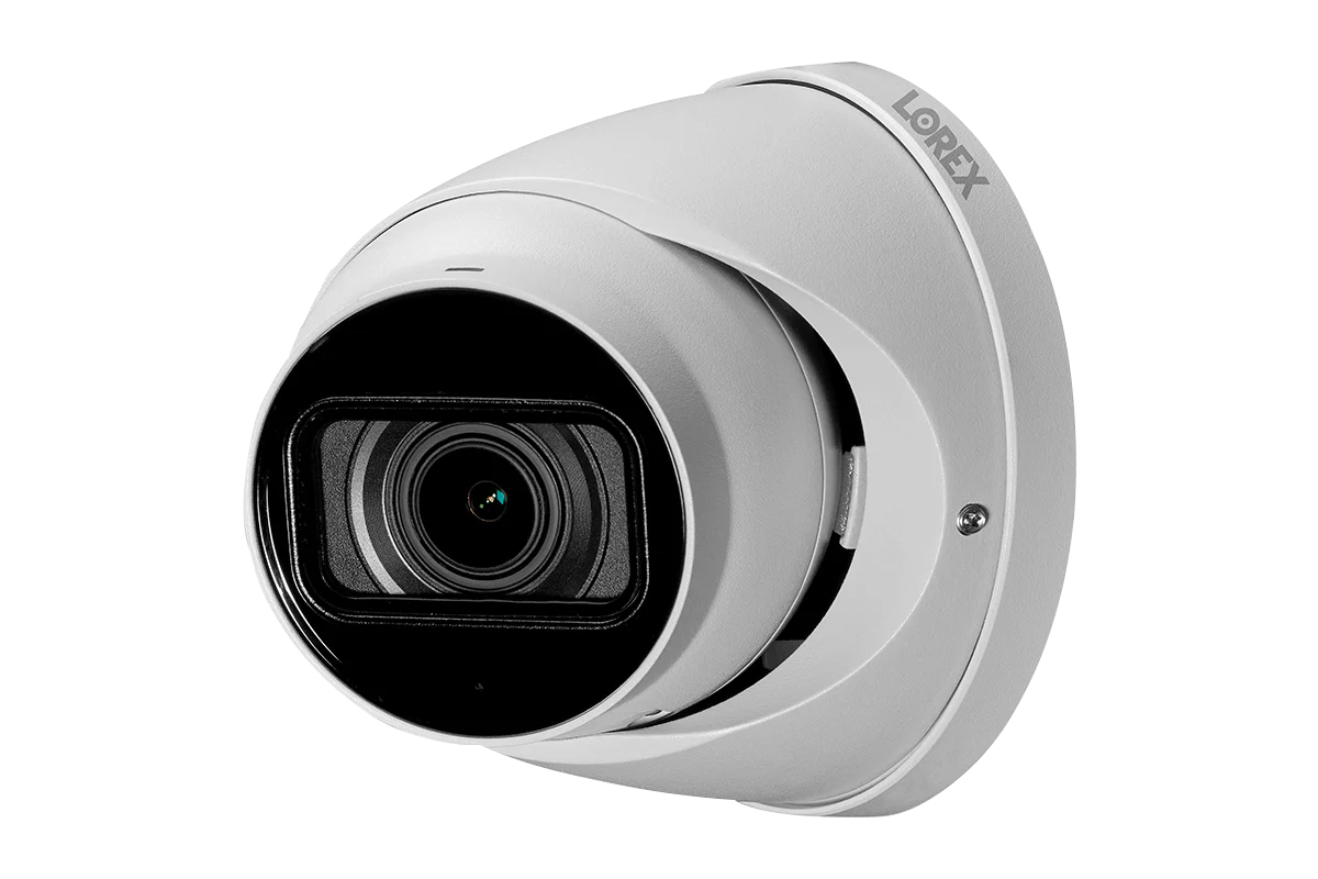 White security camera with black lens on a white background